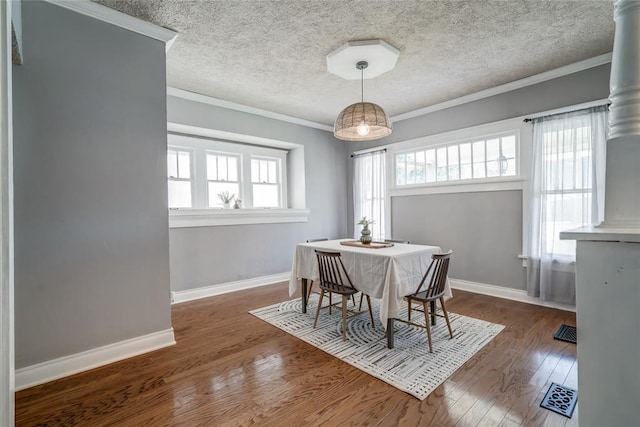 904 NW 19th St, Oklahoma City, OK 73106 - dining space with wood finished floors, crown molding, and a textured ceiling
