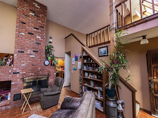 14345 N Harrah Rd, Luther, OK 73054 - living area featuring a textured ceiling, a fireplace, tile patterned flooring, and stairway