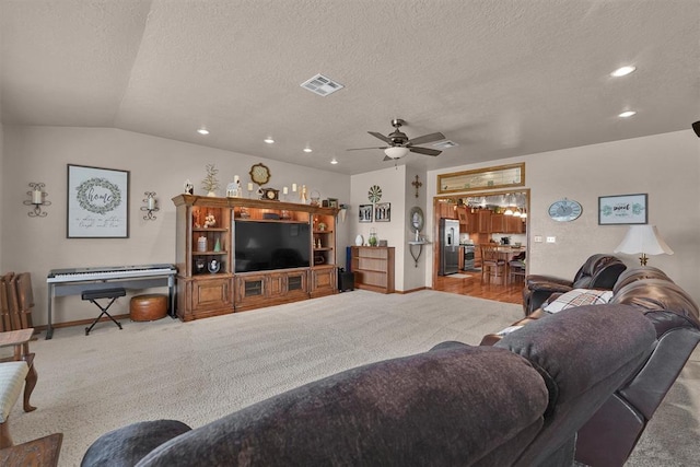 22071 E 1250th Rd, Rocky, OK 73661 - carpeted living room with a textured ceiling, ceiling fan, recessed lighting, and lofted ceiling