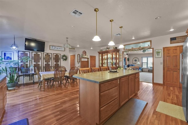 22071 E 1250th Rd, Rocky, OK 73661 - kitchen featuring light wood-style flooring, a center island, hanging light fixtures, recessed lighting, and open floor plan