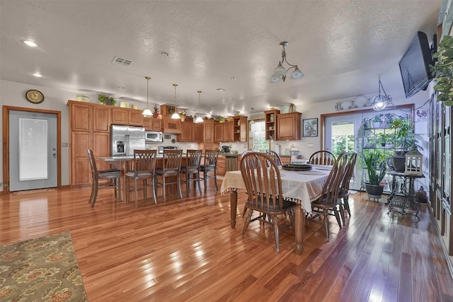 22071 E 1250th Rd, Rocky, OK 73661 - dining space featuring light wood-style flooring, a textured ceiling, and recessed lighting