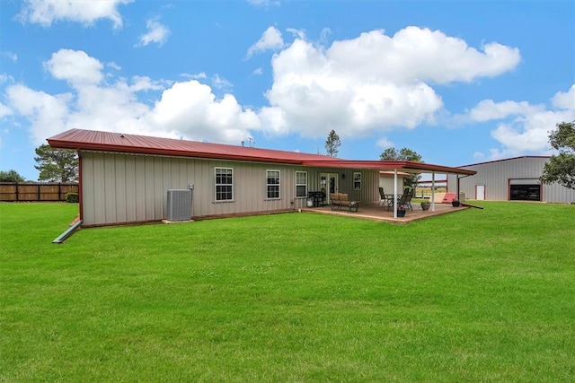 22071 E 1250th Rd, Rocky, OK 73661 - rear view of property featuring board and batten siding, a patio area, a garage, and an outdoor structure