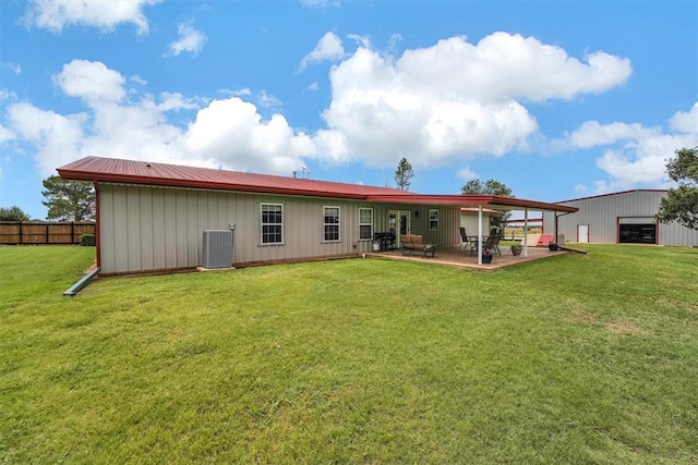 22071 E 1250th Rd, Rocky, OK 73661 - rear view of house featuring board and batten siding, a patio, and an outbuilding