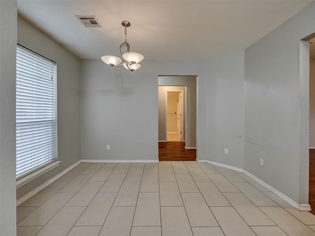 12300 NW 4th St, Yukon, OK 73099 - unfurnished room featuring a chandelier and plenty of natural light