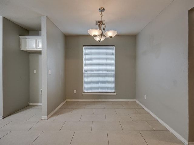 12300 NW 4th St, Yukon, OK 73099 - spare room with light tile patterned floors and a chandelier
