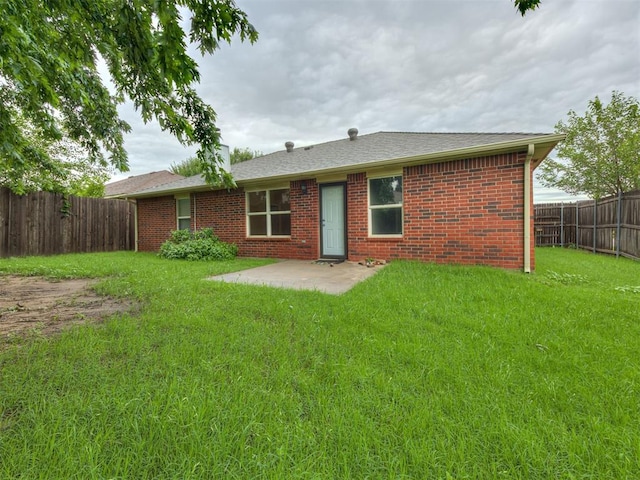 12300 NW 4th St, Yukon, OK 73099 - rear view of property with a fenced backyard, brick siding, a patio area, and roof with shingles