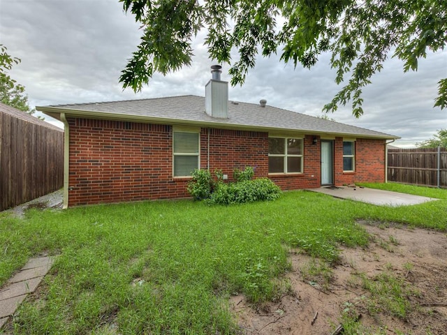 12300 NW 4th St, Yukon, OK 73099 - back of property with a patio, brick siding, a chimney, and a fenced backyard