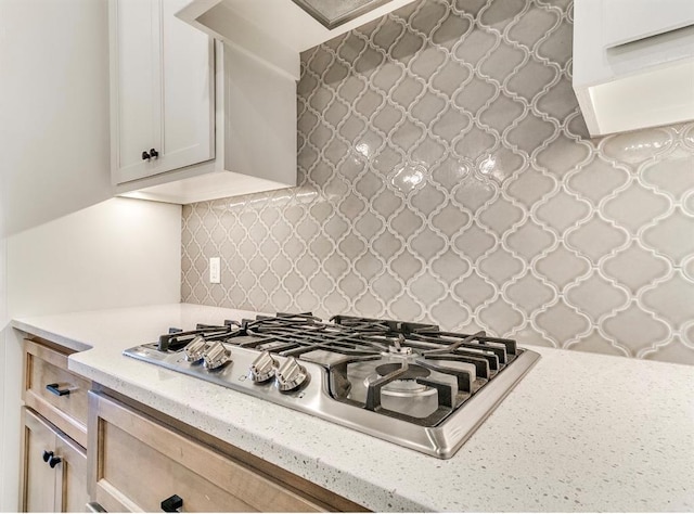 8401 Poplar Dr, Edmond, OK 73034 - kitchen featuring stainless steel gas stovetop, decorative backsplash, and light stone countertops
