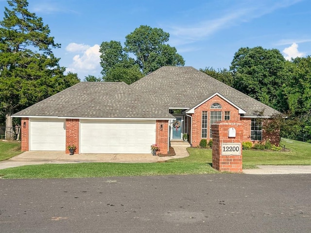 12200 Whispering Pnes, Guthrie, OK 73044 - view of front of property featuring an attached garage, driveway, a front yard, brick siding, and roof with shingles