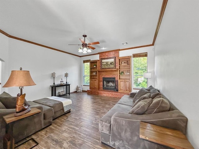 12200 Whispering Pnes, Guthrie, OK 73044 - living area with crown molding, ceiling fan, wood finished floors, and a brick fireplace