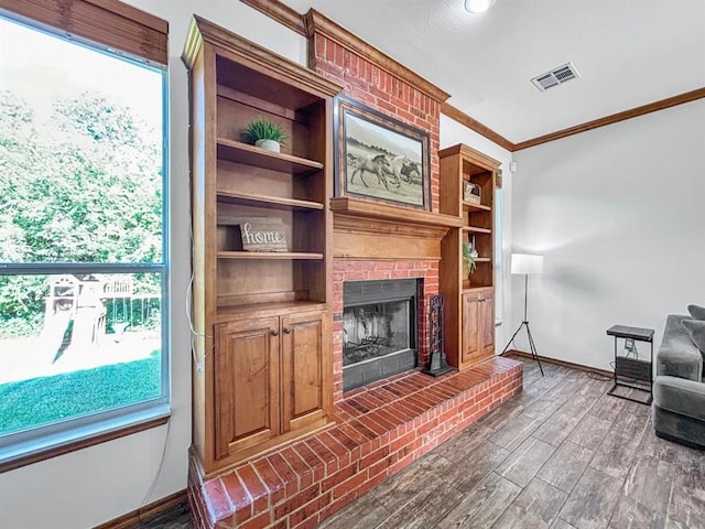 12200 Whispering Pnes, Guthrie, OK 73044 - living room featuring crown molding, a fireplace, and wood finished floors