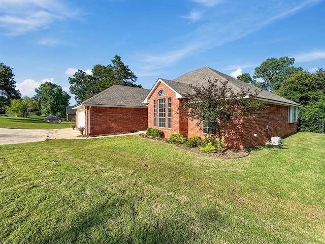 12200 Whispering Pnes, Guthrie, OK 73044 - view of side of property with driveway, brick siding, a lawn, an attached garage, and roof with shingles