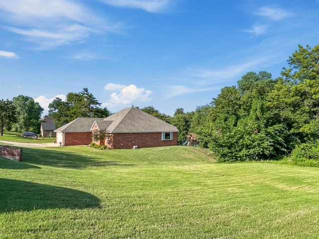 12200 Whispering Pnes, Guthrie, OK 73044 - view of side of home with a yard and brick siding