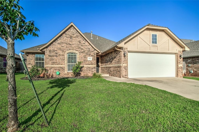 3904 Normandy Rd, Edmond, OK 73013 - view of front facade featuring brick siding, a front yard, driveway, an attached garage, and roof with shingles