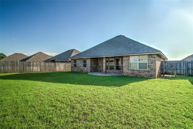3904 Normandy Rd, Edmond, OK 73013 - back of property featuring a patio, a fenced backyard, roof with shingles, and brick siding
