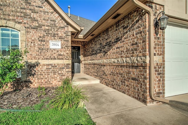 3904 Normandy Rd, Edmond, OK 73013 - property entrance featuring brick siding and an attached garage
