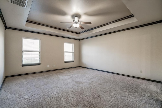 3904 Normandy Rd, Edmond, OK 73013 - carpeted spare room featuring a tray ceiling, ornamental molding, and a ceiling fan