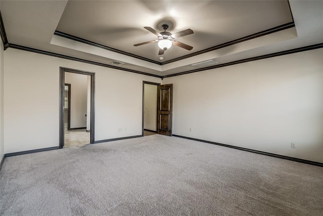 3904 Normandy Rd, Edmond, OK 73013 - empty room featuring a raised ceiling, ceiling fan, ornamental molding, and light carpet