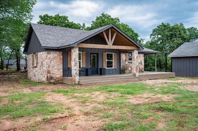 14500 Williams Way, Luther, OK 73054 - rear view of property with stone siding, a porch, and roof with shingles