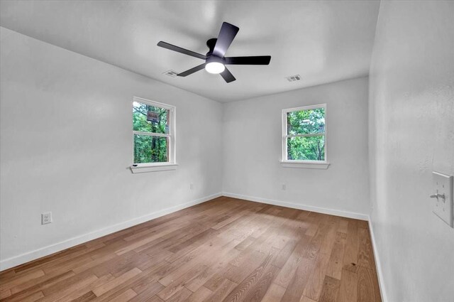 14500 Williams Way, Luther, OK 73054 - unfurnished room featuring healthy amount of natural light, wood finished floors, and a ceiling fan