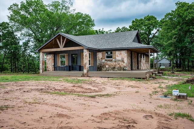 14500 Williams Way, Luther, OK 73054 - view of front of house featuring stone siding, covered porch, and a shingled roof