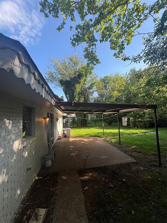 833 S Scott St, Del City, OK 73115 - view of side of home featuring a patio area and brick siding