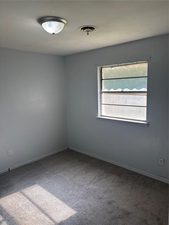 833 S Scott St, Del City, OK 73115 - carpeted empty room with baseboards