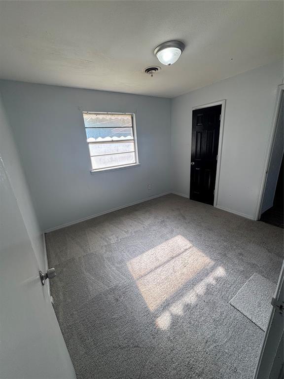 833 S Scott St, Del City, OK 73115 - unfurnished bedroom with carpet and baseboards