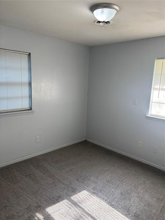833 S Scott St, Del City, OK 73115 - empty room with carpet flooring and baseboards