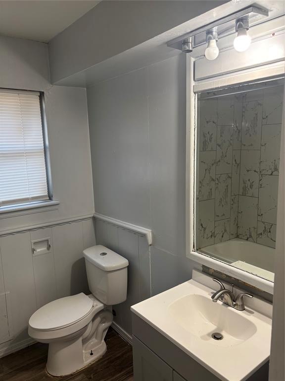 833 S Scott St, Del City, OK 73115 - full bathroom with vanity, wood finished floors, and a shower