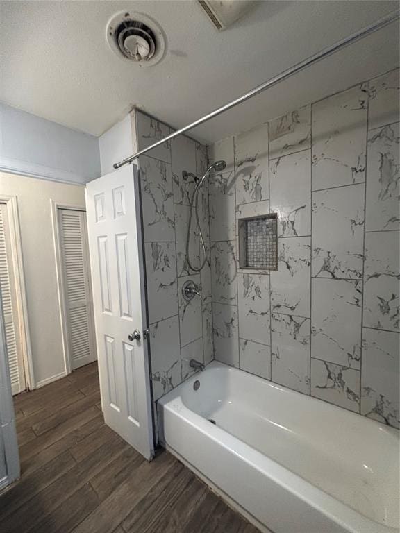 833 S Scott St, Del City, OK 73115 - full bathroom featuring wood finished floors, bathtub / shower combination, and a closet