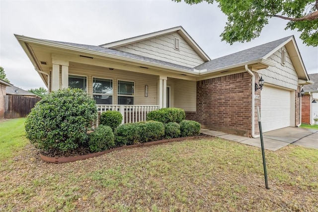 2718 Sharpish Way, Norman, OK 73069 - view of front of house featuring a garage, brick siding, covered porch, roof with shingles, and concrete driveway