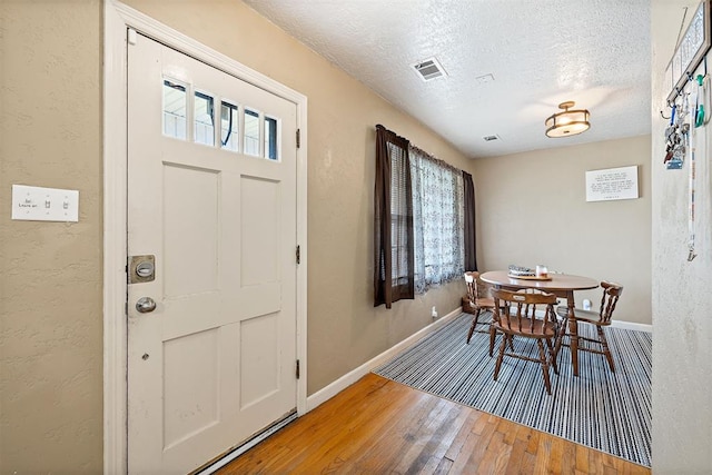 3409 S 4th St, Chickasha, OK 73018 - dining area with wood-type flooring, healthy amount of natural light, and a textured ceiling