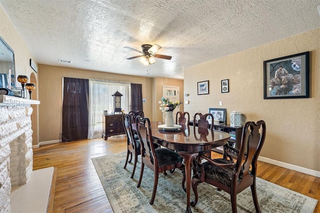 3409 S 4th St, Chickasha, OK 73018 - dining room with a textured wall, a textured ceiling, ceiling fan, and light wood-style flooring