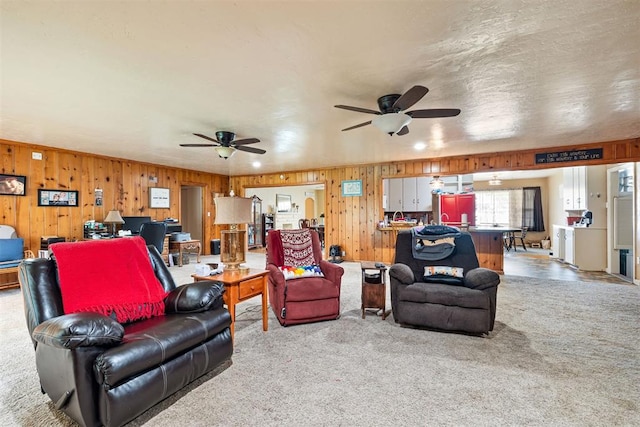 3409 S 4th St, Chickasha, OK 73018 - carpeted living area with a ceiling fan and wooden walls