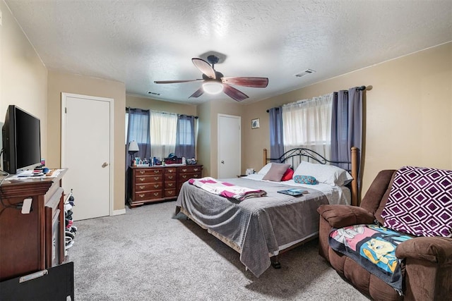 3409 S 4th St, Chickasha, OK 73018 - bedroom featuring carpet, a textured ceiling, and a ceiling fan