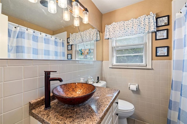 3409 S 4th St, Chickasha, OK 73018 - full bath featuring tile walls, vanity, wainscoting, and a shower with shower curtain