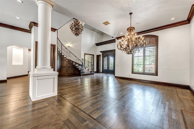 6516 NW Grand Blvd, Nichols Hills, OK 73116 - entryway with ornate columns, dark wood-style floors, crown molding, a chandelier, and arched walkways