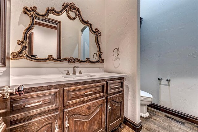 6516 NW Grand Blvd, Nichols Hills, OK 73116 - bathroom featuring wood finished floors and vanity