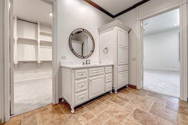 6516 NW Grand Blvd, Nichols Hills, OK 73116 - bathroom featuring stone tile flooring, ornamental molding, and vanity
