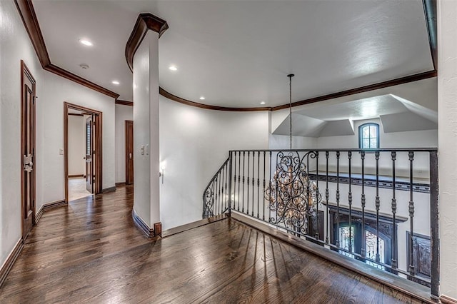 6516 NW Grand Blvd, Nichols Hills, OK 73116 - hallway featuring ornamental molding, wood finished floors, and an upstairs landing