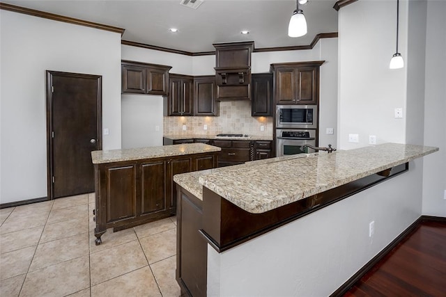16312 Old Elm Ln, Edmond, OK 73013 - kitchen featuring stainless steel appliances, dark brown cabinetry, a peninsula, tasteful backsplash, and crown molding
