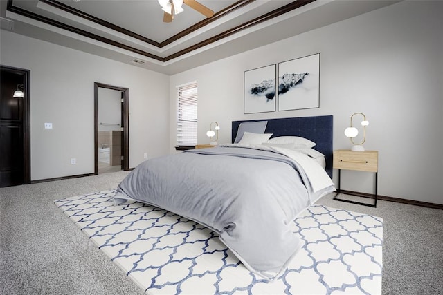 16312 Old Elm Ln, Edmond, OK 73013 - bedroom featuring carpet flooring, a tray ceiling, ornamental molding, ensuite bath, and a ceiling fan