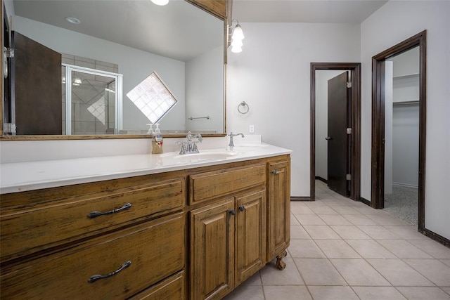 16312 Old Elm Ln, Edmond, OK 73013 - full bathroom featuring a shower stall, vanity, tile patterned flooring, and a walk in closet