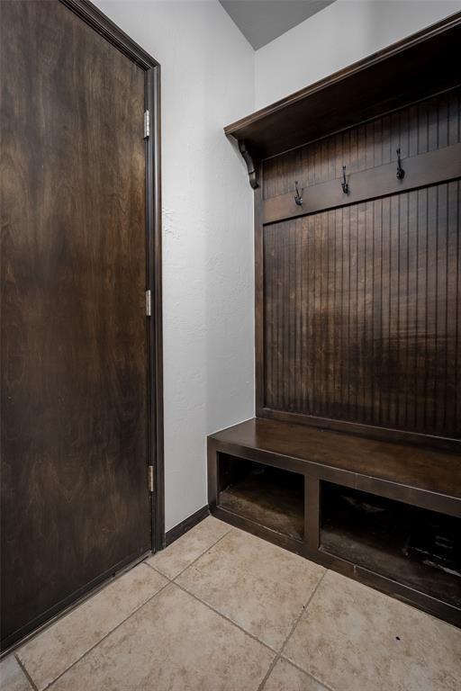 16312 Old Elm Ln, Edmond, OK 73013 - mudroom with light tile patterned flooring and baseboards