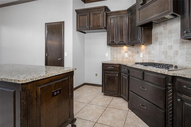 16312 Old Elm Ln, Edmond, OK 73013 - kitchen with stainless steel gas cooktop, decorative backsplash, dark brown cabinets, and light tile patterned floors