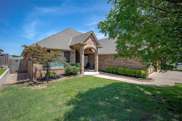 16312 Old Elm Ln, Edmond, OK 73013 - french country style house with brick siding, a shingled roof, driveway, and a gate
