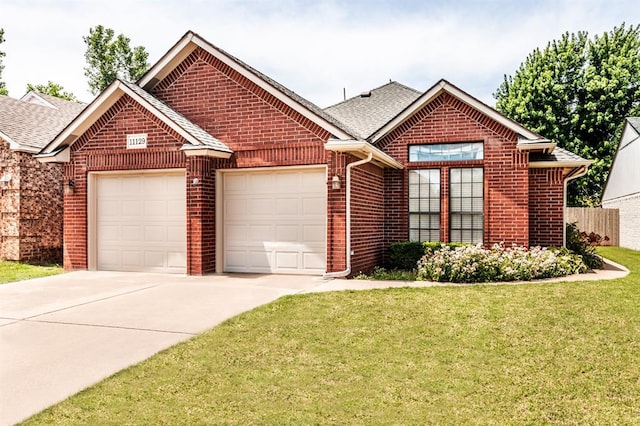 11129 Springhollow Ct, Oklahoma City, OK 73120 - view of front of property with brick siding, an attached garage, driveway, and a shingled roof