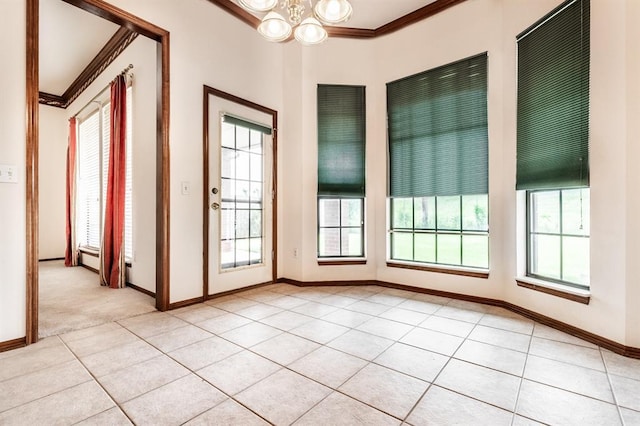 11129 Springhollow Ct, Oklahoma City, OK 73120 - empty room with crown molding, light tile patterned floors, and a chandelier