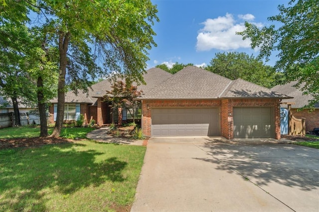 108 N Bradbury Dr, Edmond, OK 73034 - view of front facade with a garage, brick siding, concrete driveway, and a front yard
